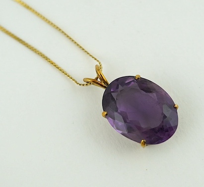 A yellow metal mounted oval facetted amethyst pendant, overall 27mm, on 14K gold flattened S link chain, gross weight 7 grams. Condition - good